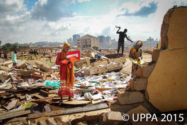 A pupil of Nabagereka Primary School searches for remains of her notes in the debris left behind after an investor razed her school. The institution, named after the Queens of the Buganda Kingdom, was home to over 600 pupils and over 50 staff. The school was razed in the early hours of the morning to avoid the move being opposed.